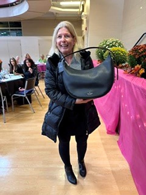 A bingo winner holding up her new purse